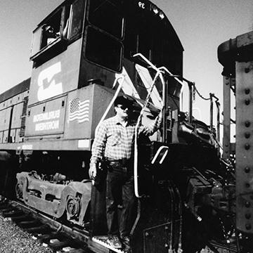 A man stands on a Burlington Northern Railroad car at 赌钱app可以微信提现.