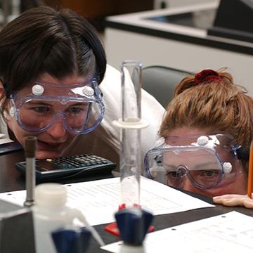 Two healthcare students look over a science project.